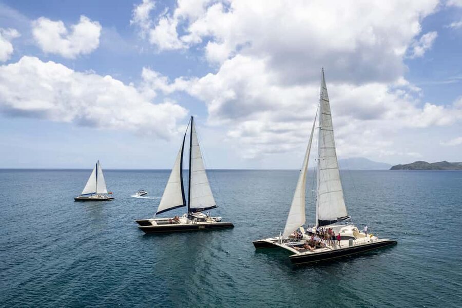 Basseterre: St. Kitts and Nevis Catamaran Tour with Lunch - Crossing the Narrows with a drink in hand